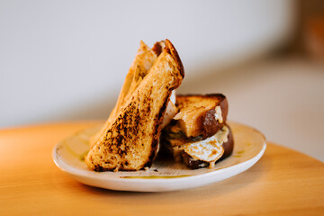 Tender melt with chicken served on a plate featuring golden brown toasted bread and creamy filling