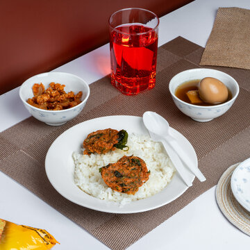 A delicious thai local food with tea on white table and red background.