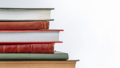 Fototapeta premium Stack of books with various colors and sizes against a plain background 