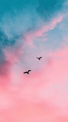Fototapeta premium Silhouettes of Birds in Flight Against a Vibrant Pink and Purple Sunset Sky