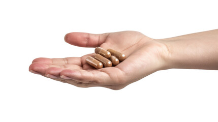 Hand holding brown supplement capsules on transparent background