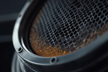 Close-up of a honeycomb-patterned speaker grille.