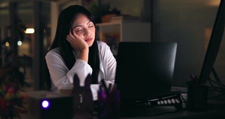 Tired woman, sleeping and night with laptop for deadline, insomnia or fatigue at office. Exhausted,...