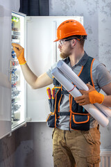 Male construction worker in overalls. Male electrician in overalls.