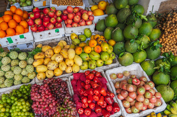 A counter with tropical fruits at an Asian local market in Vietnam.