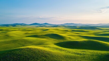 Aerial landscapes nature concept. Vast green hills under a clear blue sky, showcasing nature's beauty and tranquility.