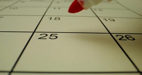 A person circles a number in the schedule table with a red marker. Close-up of the marker, an...