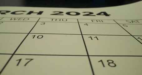 A schedule table with days of the week and numbers. One of the dates is crossed out with a red cross. Close-up