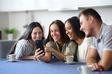 Fototapeta premium Happy interracial group of friends using phone