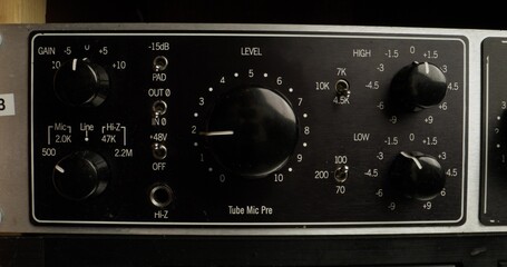 A man adjusts a device to measure the sound level, close-up of his hand, an unrecognizable person