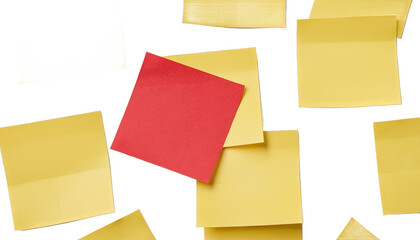 Fototapeta premium Red Note Amongst Yellow Sticky Notes: A vibrant red sticky note stands out amongst a cluster of yellow sticky notes, suggesting ideas, reminders, or a unique concept. PNG