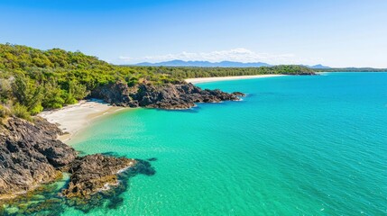 Obraz premium Coastal scenic nature idea. A breathtaking view of a tranquil beach with turquoise waters and rocky coastline.