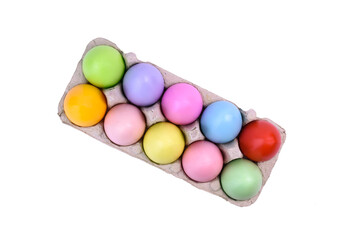 Easter colored eggs in a tray on a white background