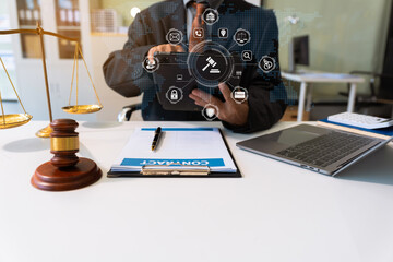 Justice and law concept. male judge in a courtroom the gavel, working with document and digital tablet computer.