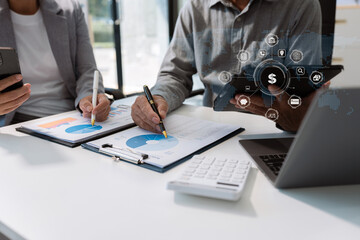 Close up Businessman and partner using calculator and laptop for calculation finance, tax, accounting, statistics and analytic research concept. in the office.