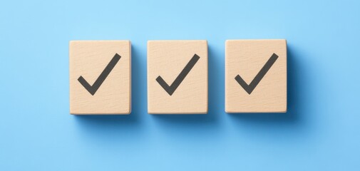 Three wooden blocks with check marks displayed on a blue background, symbolizing tasks completed, organization, and productivity in a professional setting.