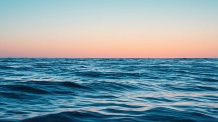 Fototapeta premium Calm Ocean Waves Under a Soft Sunset Sky with Warm Colors