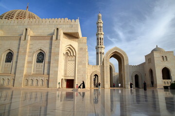 The Sultan Qaboos Grand Mosque in Muscat, Oman, with patterned tiles and reflections