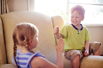 Happy, children and playing game on sofa with rock paper scissors, sibling fun and bonding together. Smile, kids and activity for friendly competition, family connection and challenge choice at house