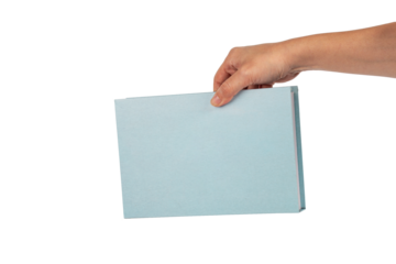Blank blue book cover in hand on transparent background.