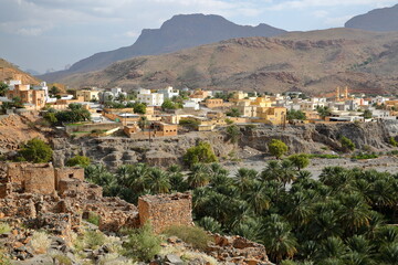 Ghul village, located 12 km west of Al Hamra and on the road to Jebel Shams, Al Dakhiliyah, Oman, with the ruins of the abandoned old Ghul village in the foreground