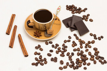 Coffee drink in cup. Spoon, sugar and star anise on saucer.