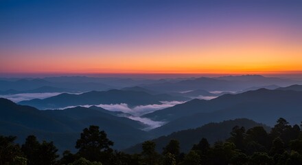 Naklejka premium Stunning Sunset Over Misty Mountain Ranges Landscape