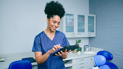 Confident Dental Professional Using Tablet in Modern Office Ready to Assist Patients