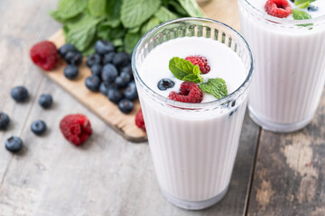 Fresh raspberry and blueberry smoothie on wooden table