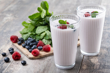 Fresh raspberry and blueberry smoothie on wooden table