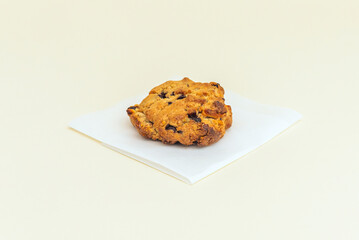 A large, irregularly shaped cookie filled with dark chocolate chips