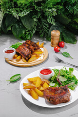 Delicious grilled meat with crispy potatoes and fresh salad presented beautifully on a table surrounded by greenery