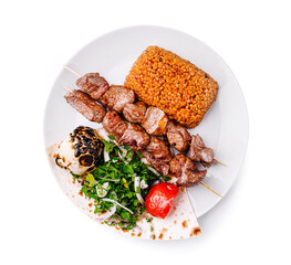 Tender skewers and flavorful side dishes create a delicious meal at a casual dining spot during lunchtime