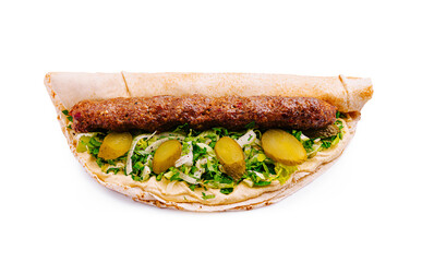 Delicious wrap with grilled meat, fresh vegetables, and pickles, served in a cozy setting