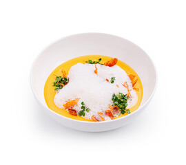 Gourmet dish featuring vibrant soup with foam and garnish served in a modern bowl