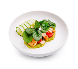 Delicious seafood dish with fresh vegetables and herbs served in a stylish bowl