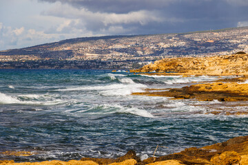 rocky coastline with crashing waves on the island of Cyprus near the city of Paphos in Greece in November