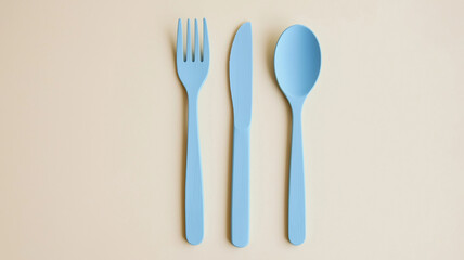 A fork, knife, and spoon are arranged on a table