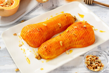 Baked pumpkin or butternut squash with honey served with roasted pine nuts. 