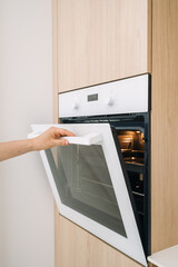 Modern kitchen with wall oven featuring minimalist design and clean lines