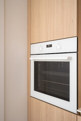 Fototapeta premium Modern kitchen design featuring a sleek built-in oven in a minimalist apartment
