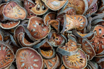 Dried slices of Bengal quince (also known as golden aple, japanes bitter orange, stone apple or wood apple) at a local market in Thailand. Latin name is Aegle marmelos.

