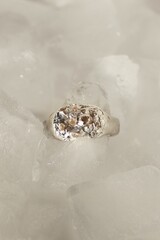 Minimalist handmade silver ring with organic texture and gemstones on ice. Handcraft precious item.
