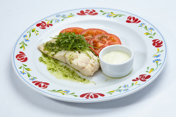 roasted fish with sauce and vegetables