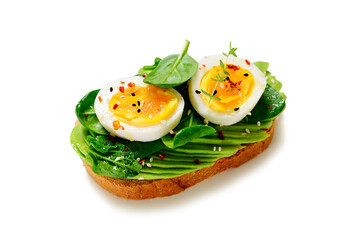 Healthy toast with sliced avocado, boiled eggs, spices and fresh spinach. Delicious breakfast or snack isolated on white background
