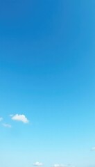 Serene blue sky with a sprinkling of delicate white cirrus clouds across the horizon, soft, vast