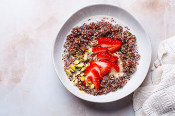 Breakfast quinoa bowl with strawberries and pistachio.