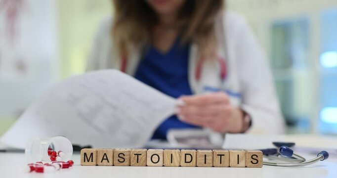 A healthcare professional carefully reviews a variety of documents associated with mastoiditis patient care procedures