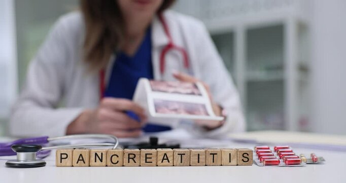 A healthcare professional discussing pancreatitis with educational materials and medications present.