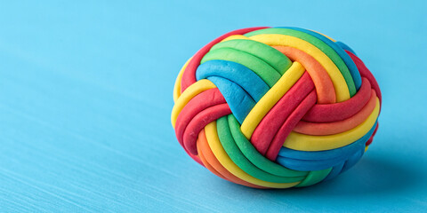 Vibrant Plasticine Ball on a Bright Blue Background for Artistic Fun